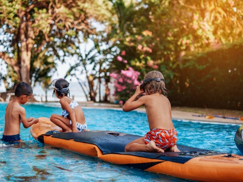 relaxed-children-swim-in-pool-together-with-boat-in-hotel.jpg